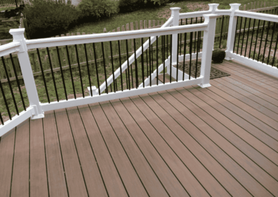 Brown deck in backyard with new steps