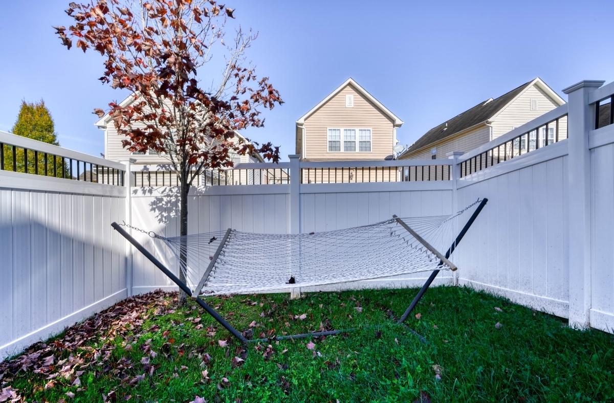 aluminum spindles privacy fence enclosing relaxing hammock spot