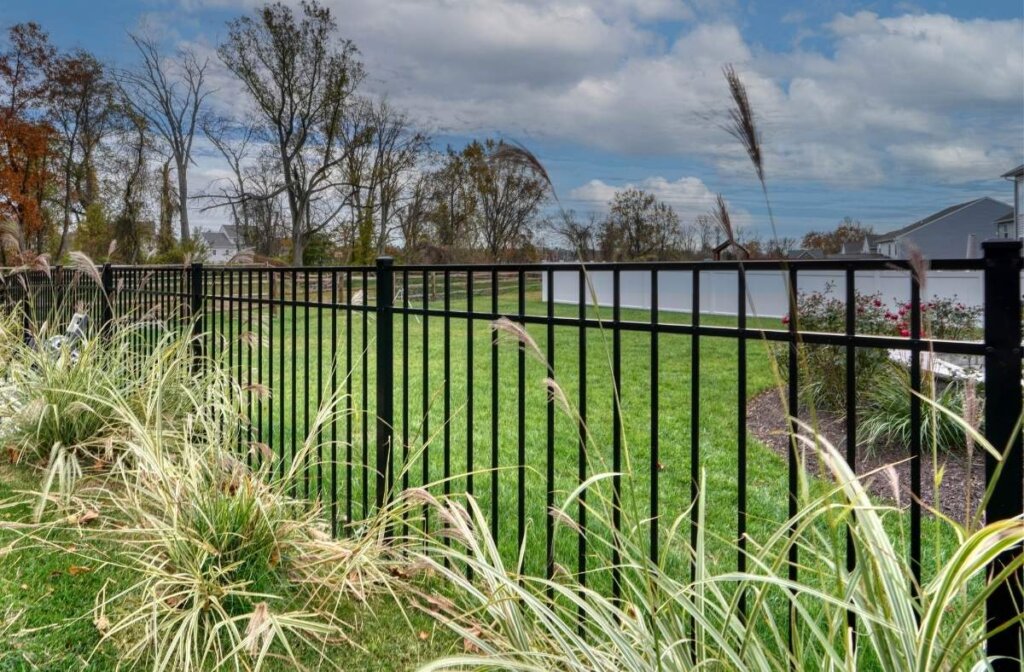 black aluminum fence around garden