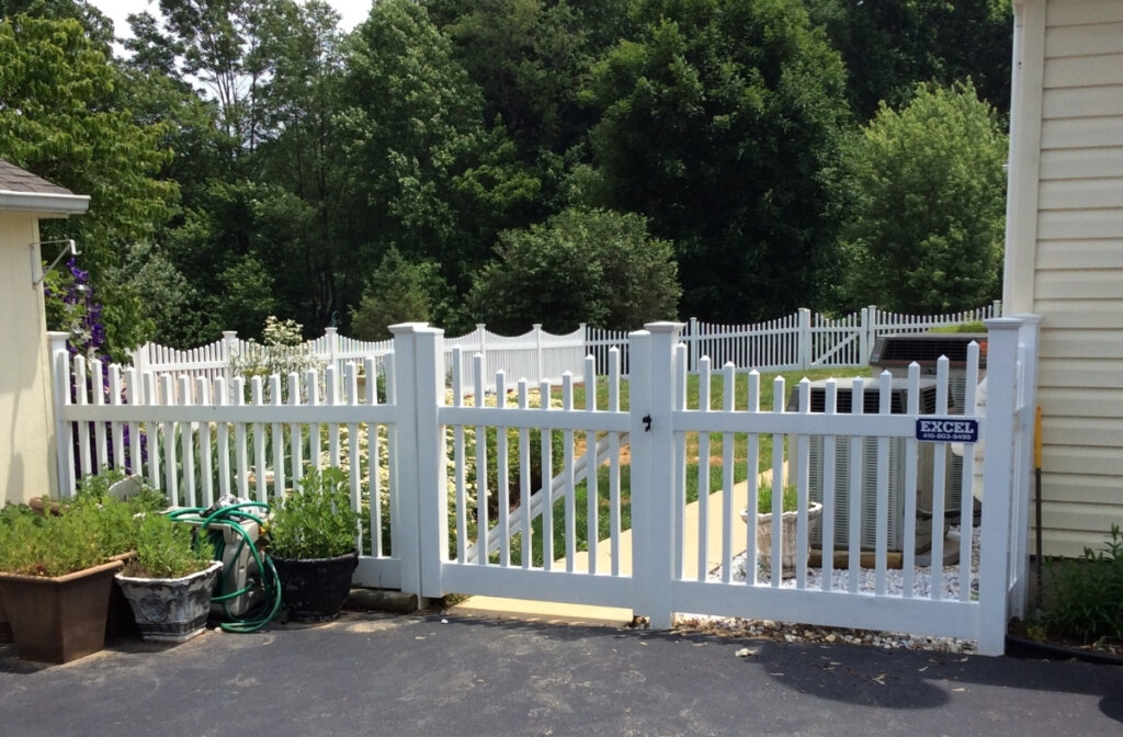 white vinyl picket fence with a single latch gate