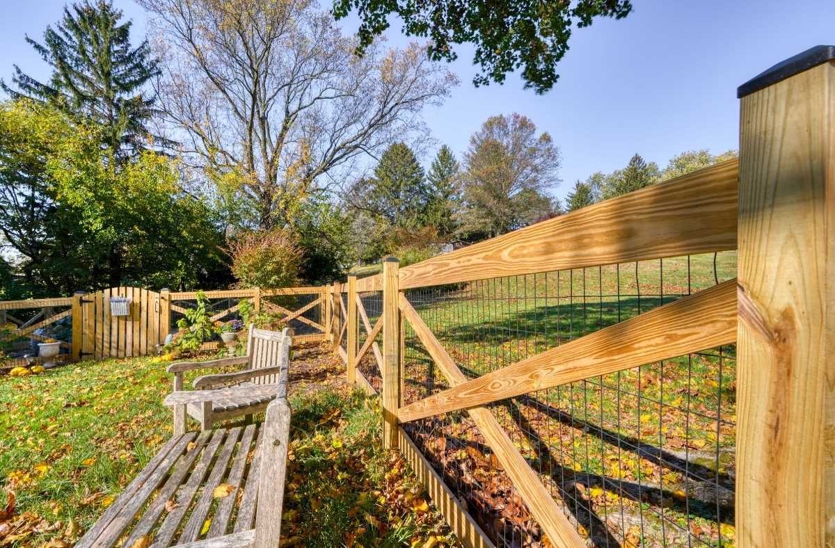 wood crossbuck fence surrounding backyard garden space