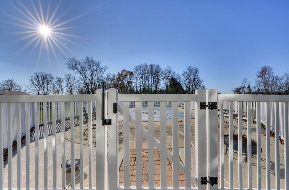 Contemporary gate around a backyard pool